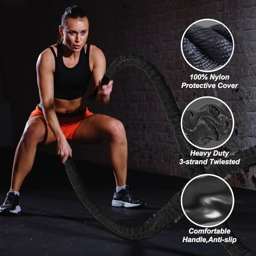 Woman exercising with battle ropes in a gym.